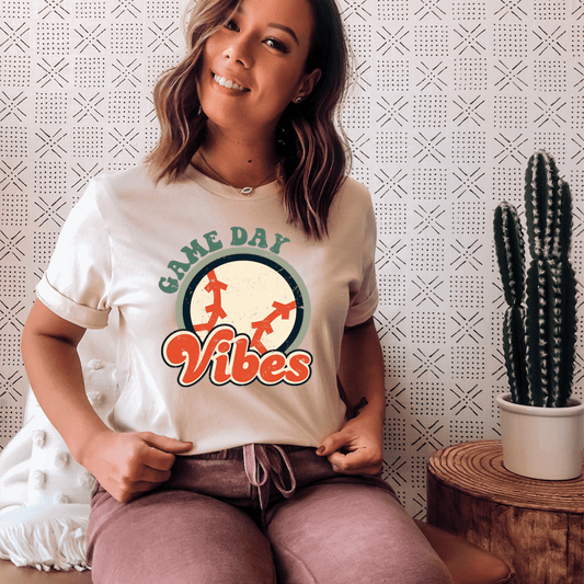 White t-shirt with circular sports graphic and green 'Game Day' text on front