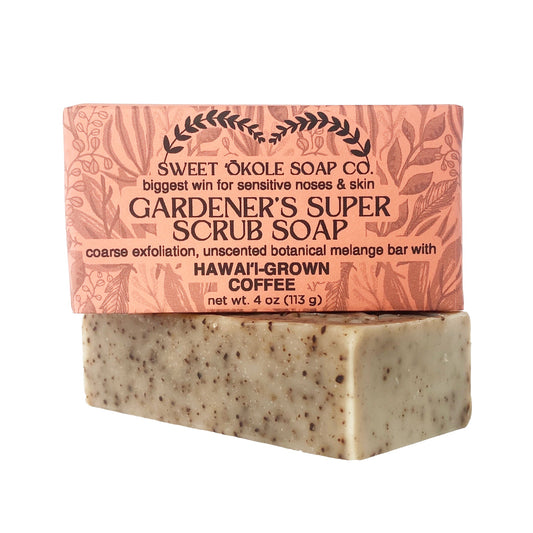 Coarse exfoliating soap bar with beige speckled texture and pink patterned wrapper
