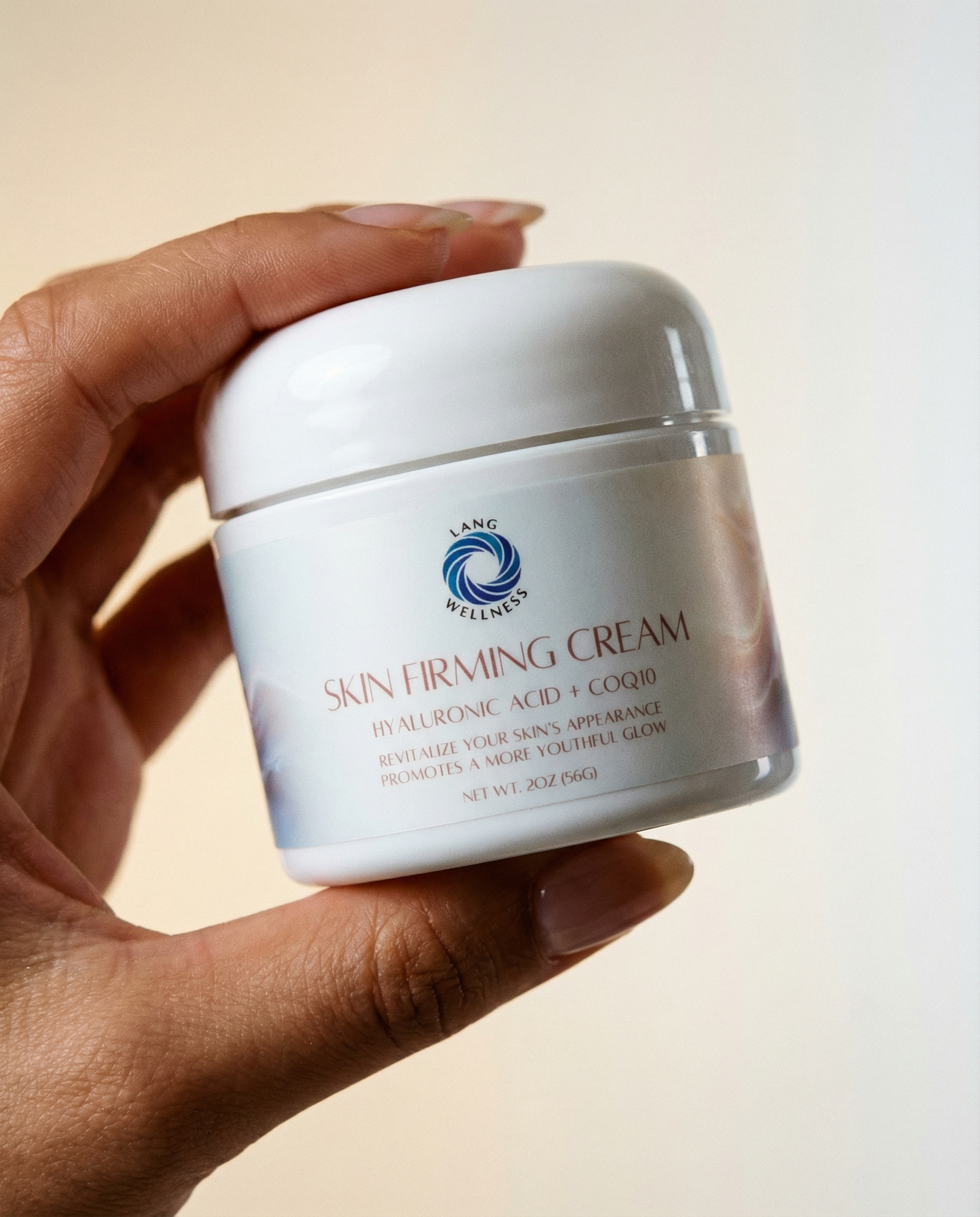 Skin firming cream jar held in hand, white lid and front label visible