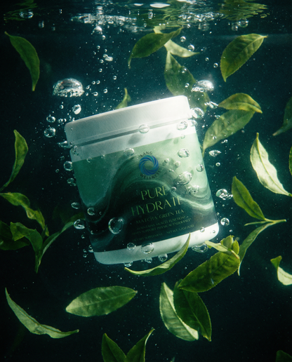 Matcha green tea hydration cream jar floating in water with green leaves