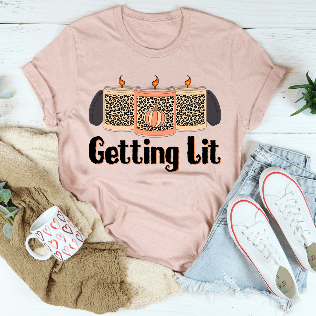 Light mauve crew-neck short-sleeve T-shirt with candle graphic and 'Getting lit' print