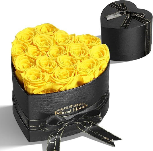Black heart-shaped gift box with yellow rose florals and satin bow ribbon