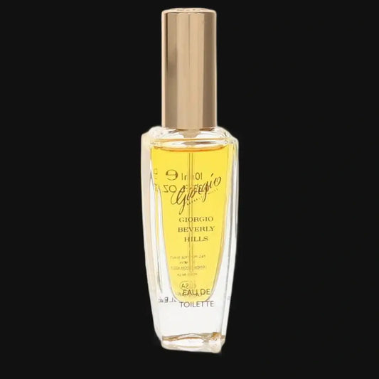 Women’s eau de toilette spray bottle, clear glass with gold-toned cap and label