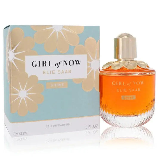 Women’s eau de parfum bottle and box; gold cap with orange-yellow liquid.