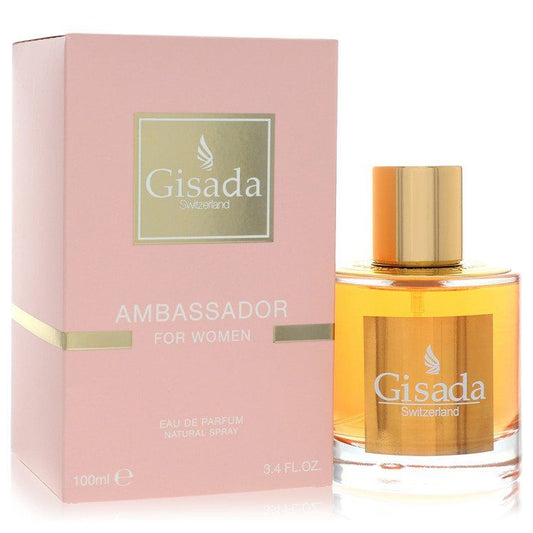 Women’s amber eau de parfum bottle with gold cap beside pink Gisada Ambassador box