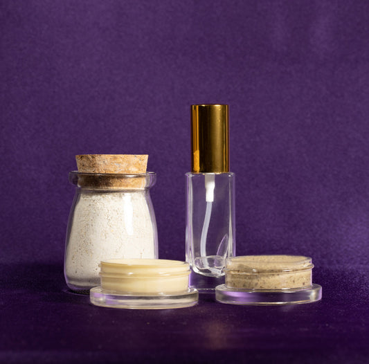 Spa bottle with gold cap and matching cream jars in a row