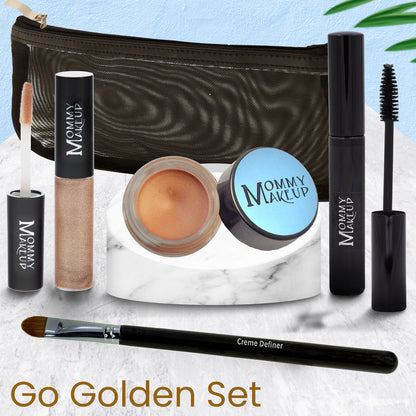 Makeup set items with dark zip pouch, including mascara, lip gloss, cream, and brush.