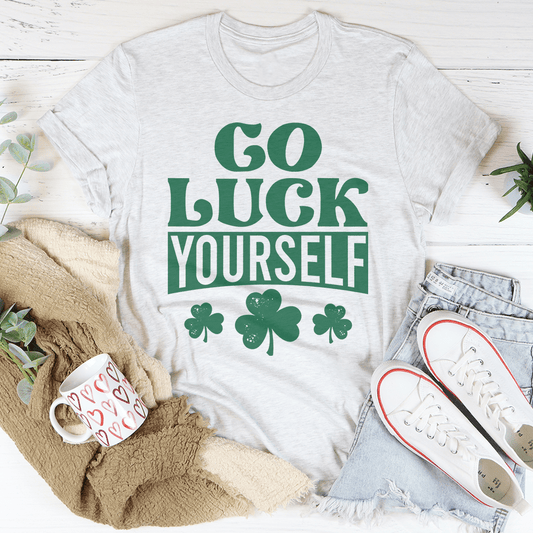Light gray crewneck T-shirt with green "Go Luck Yourself" text and clover icons