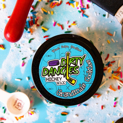 Hockey stick wax tin with 'Dirty Dangles' blue label and Grandma's Cookies name