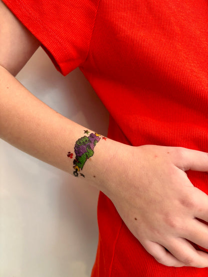 Graveyard Grip temporary kids tattoo band on wrist with purple and green chain hands