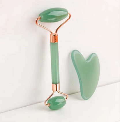 Green jade roller and gua sha tools with rose-gold metal frames