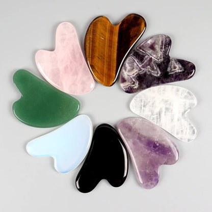 Facial gua sha stone set, assorted heart-shaped tools in rose pink, green, brown, and purple
