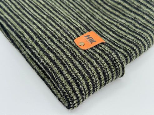 Green-and-black striped knit beanie with orange logo label on cuff