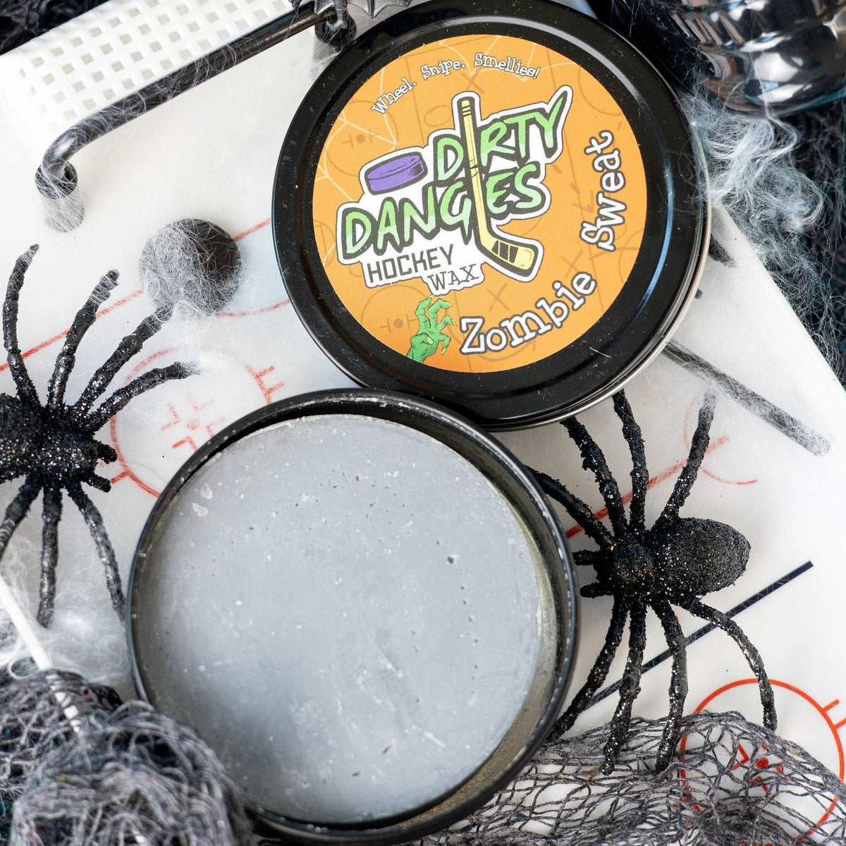 Hockey stick wax tin with black lid and orange label featuring Zombie