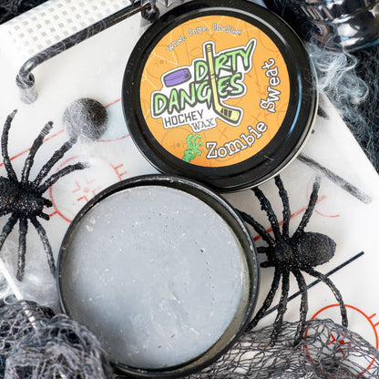 Hockey stick wax tin with black lid and orange label featuring Zombie