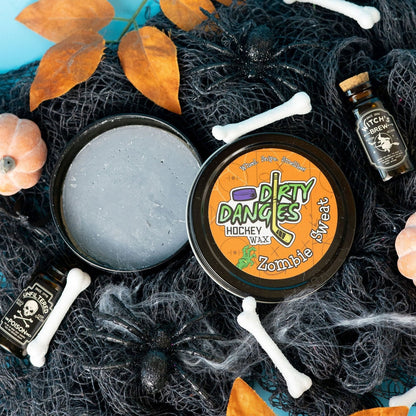 Hockey wax tin with orange Dirty Dangles Zombie Sweat label, showing gray wax top