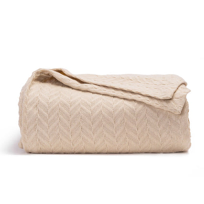 Herringbone cotton blanket, ivory, folded with folded edge and chevron knit texture