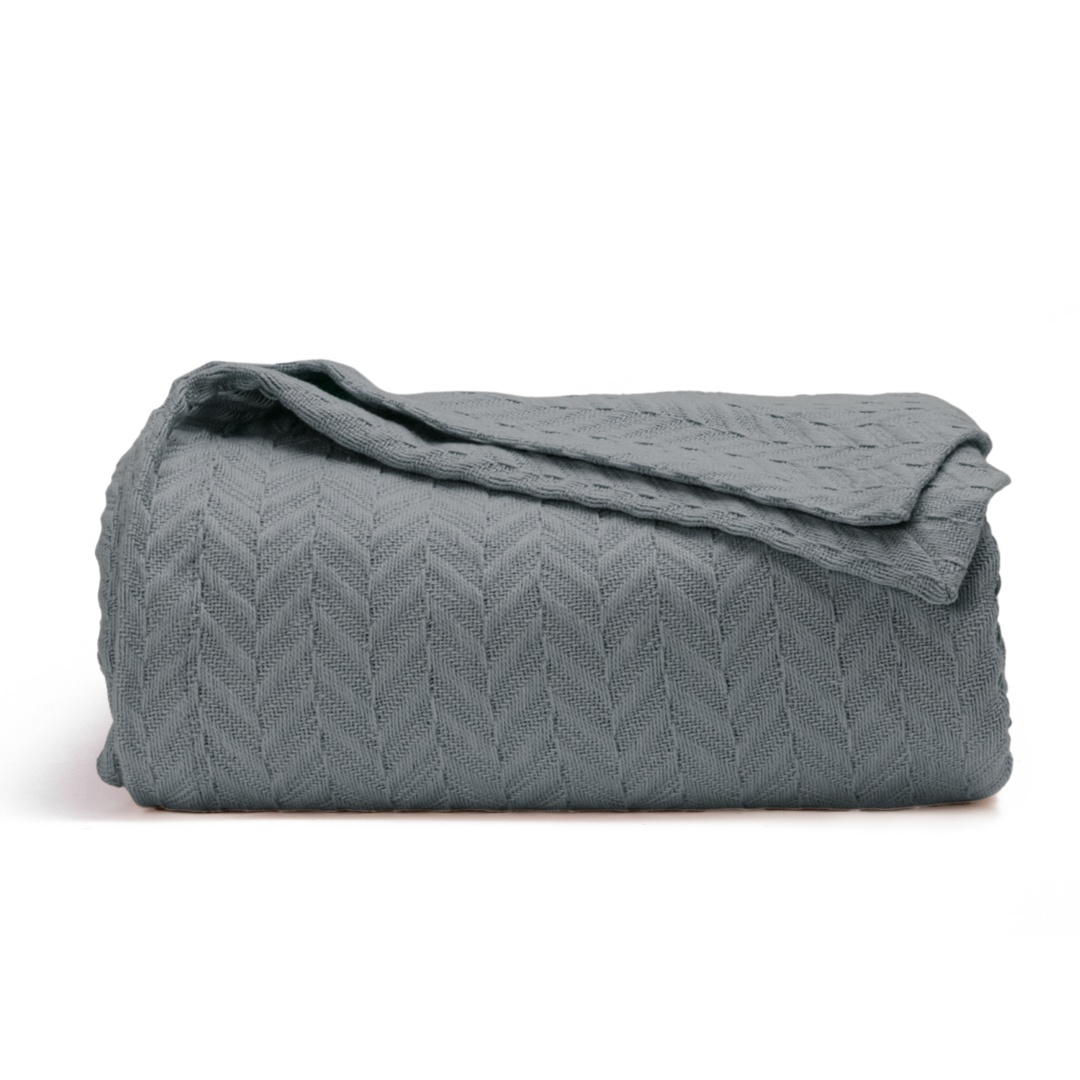Herringbone cotton blanket, gray, folded with folded top and chevron knit texture