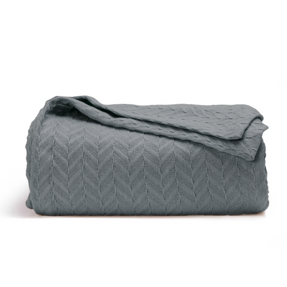 Herringbone cotton blanket, gray, folded with folded top and chevron knit texture