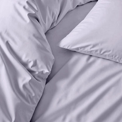 Light gray sateen sheet set close-up of smooth fabric and folds