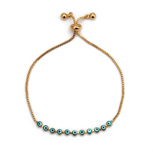 Charm bracelet with gold cord and row of blue evil-eye beads with clasp