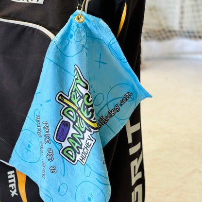Light blue towel with Dirty Dangles Hockey logo, hanging loop and text sides