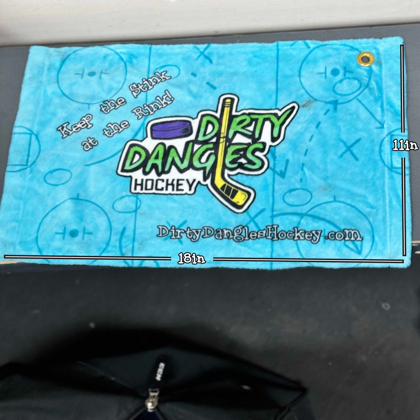 Blue towel with Dirty Dangles Hockey branding, webbed pattern, grommet hole