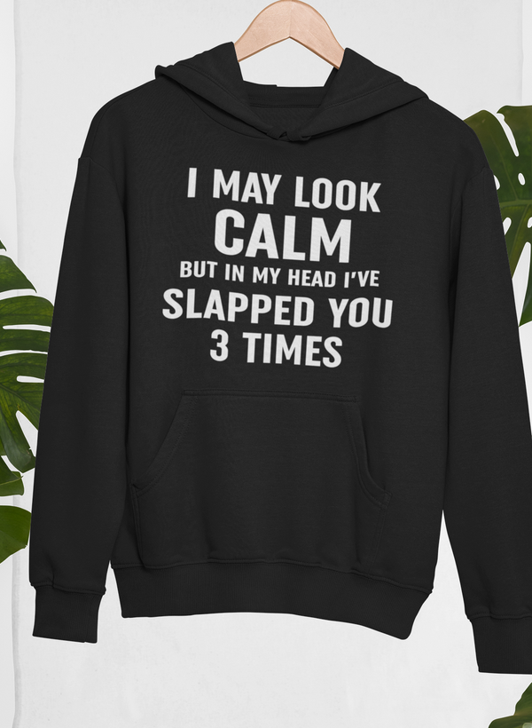 Black hoodie with front pocket and chest slogan print: I May Look Calm