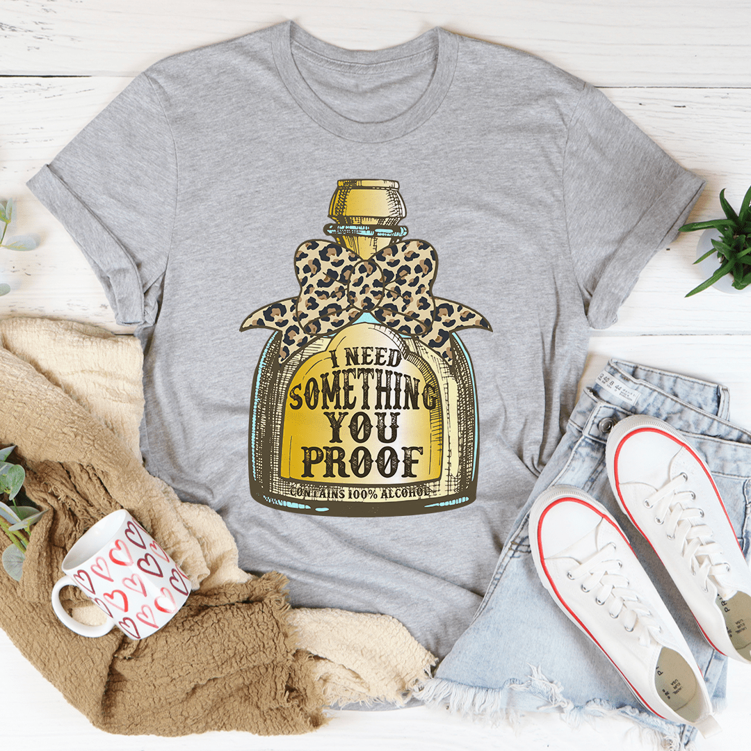 Gray T-shirt with leopard bottle graphic and I NEED SOMETHING YOU PROOF text.