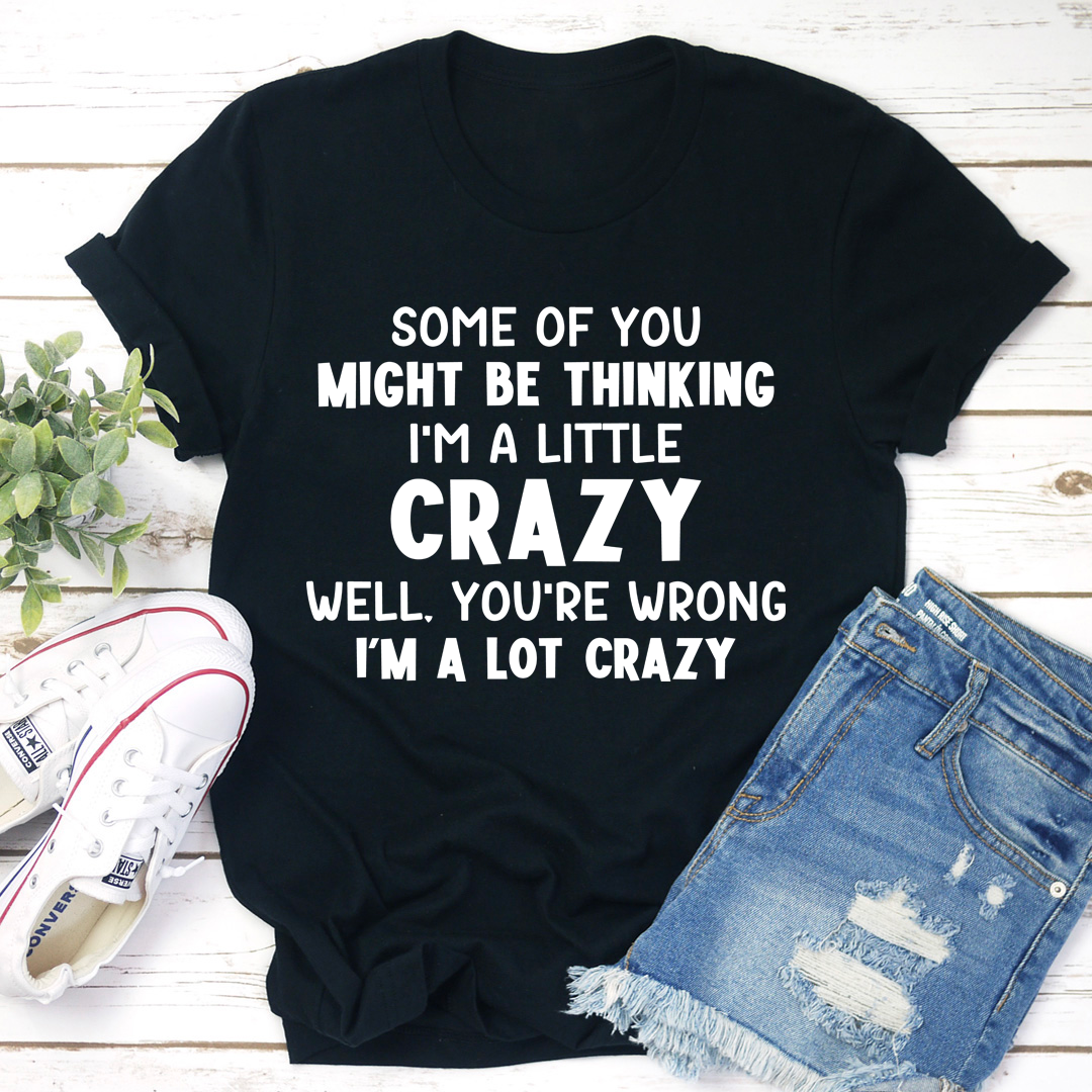 Black crewneck T-shirt with bold 'I'M A LOT CRAZY' text graphic on front