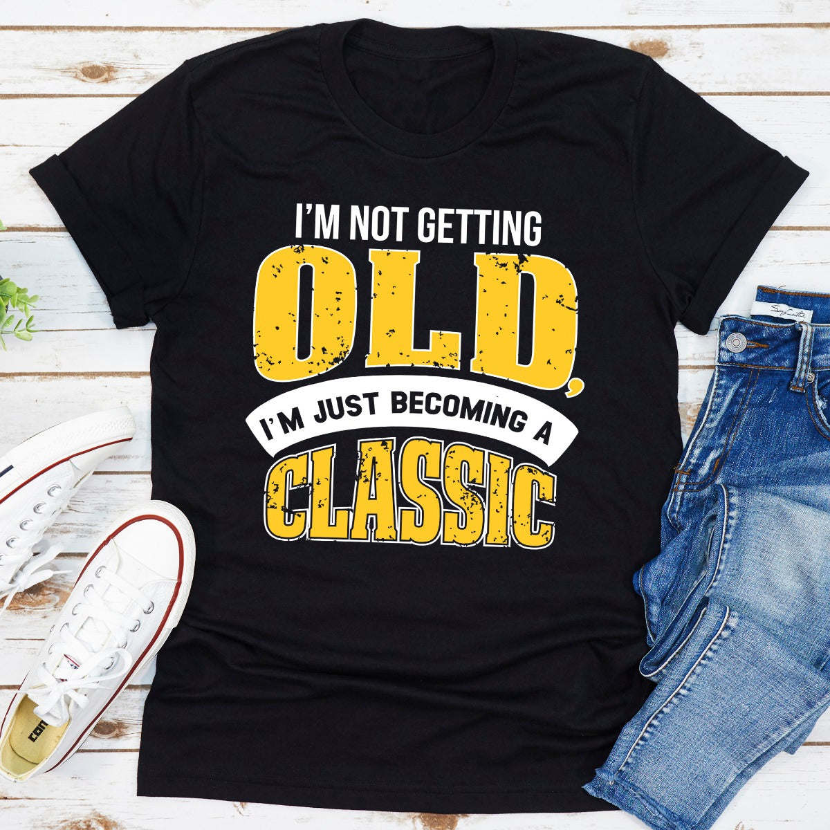 Black crewneck T-shirt with bold yellow and blue 'OLD' front graphic.
