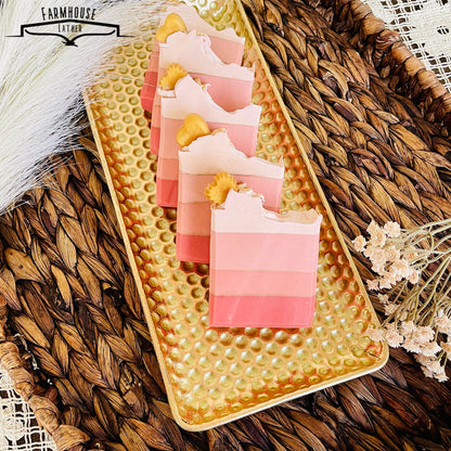 Stacked layered pink soap bars with white ruffled tops and yellow accent pieces