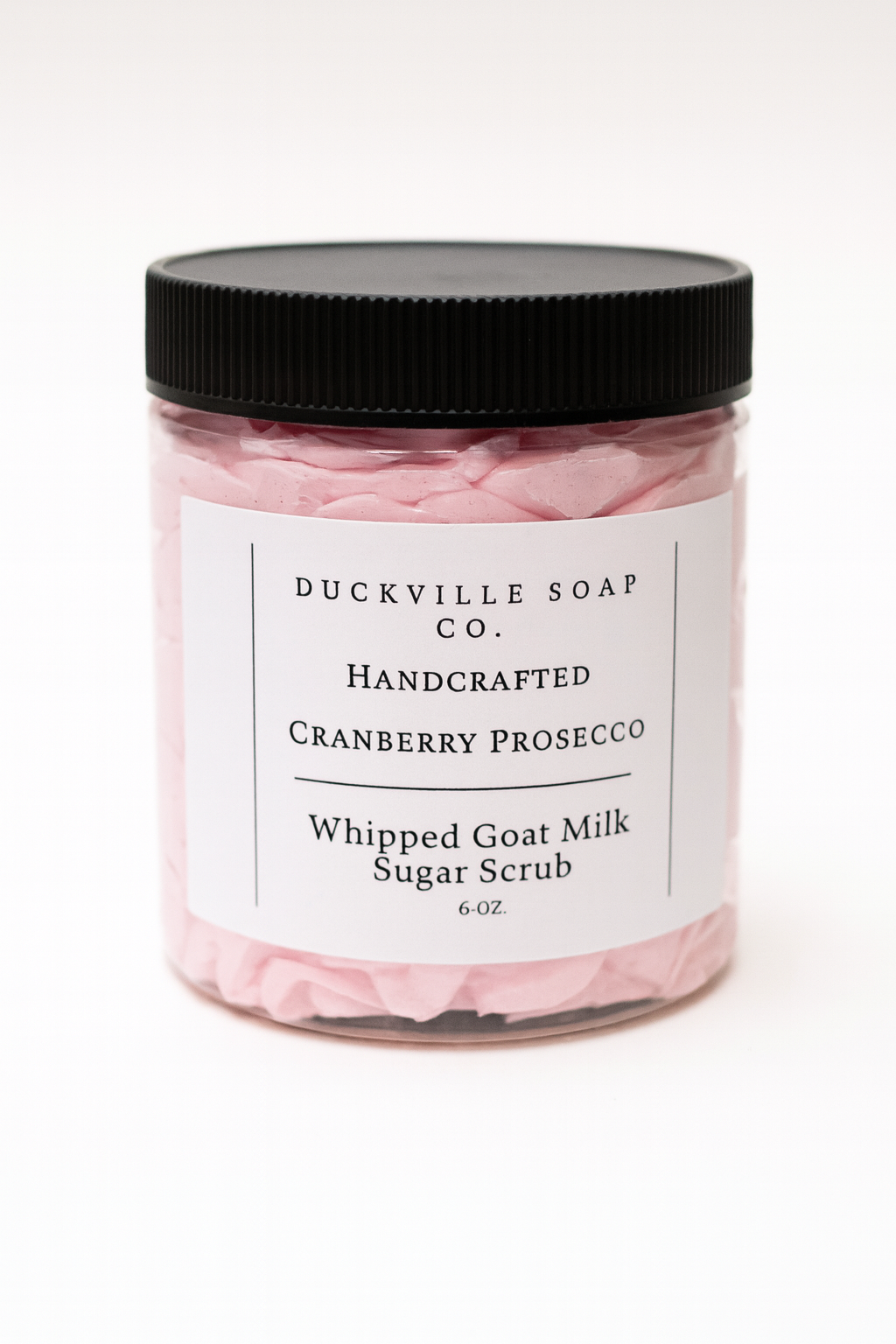 Whipped goat milk sugar scrub jar, Cranberry Prosecco label, black lid, pink flakes