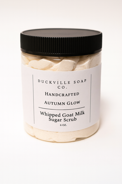 Whipped goat milk sugar scrub jar, Autumn Glow label, black lid, beige flakes