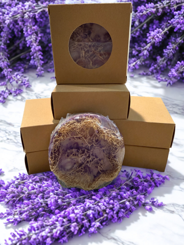 Lavender round soap bar in an open kraft box with flower accents