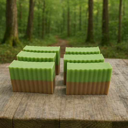 Layered bar soap with green top and brown base, rectangular with scalloped edges