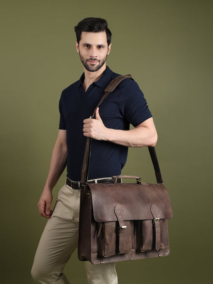 Brown buffalo leather messenger bag worn across the body with flap and front pocket details.