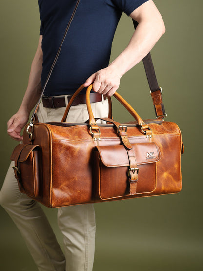 Berlin leather weekender duffle bag in brown leather with crossbody strap and front buckle organizer