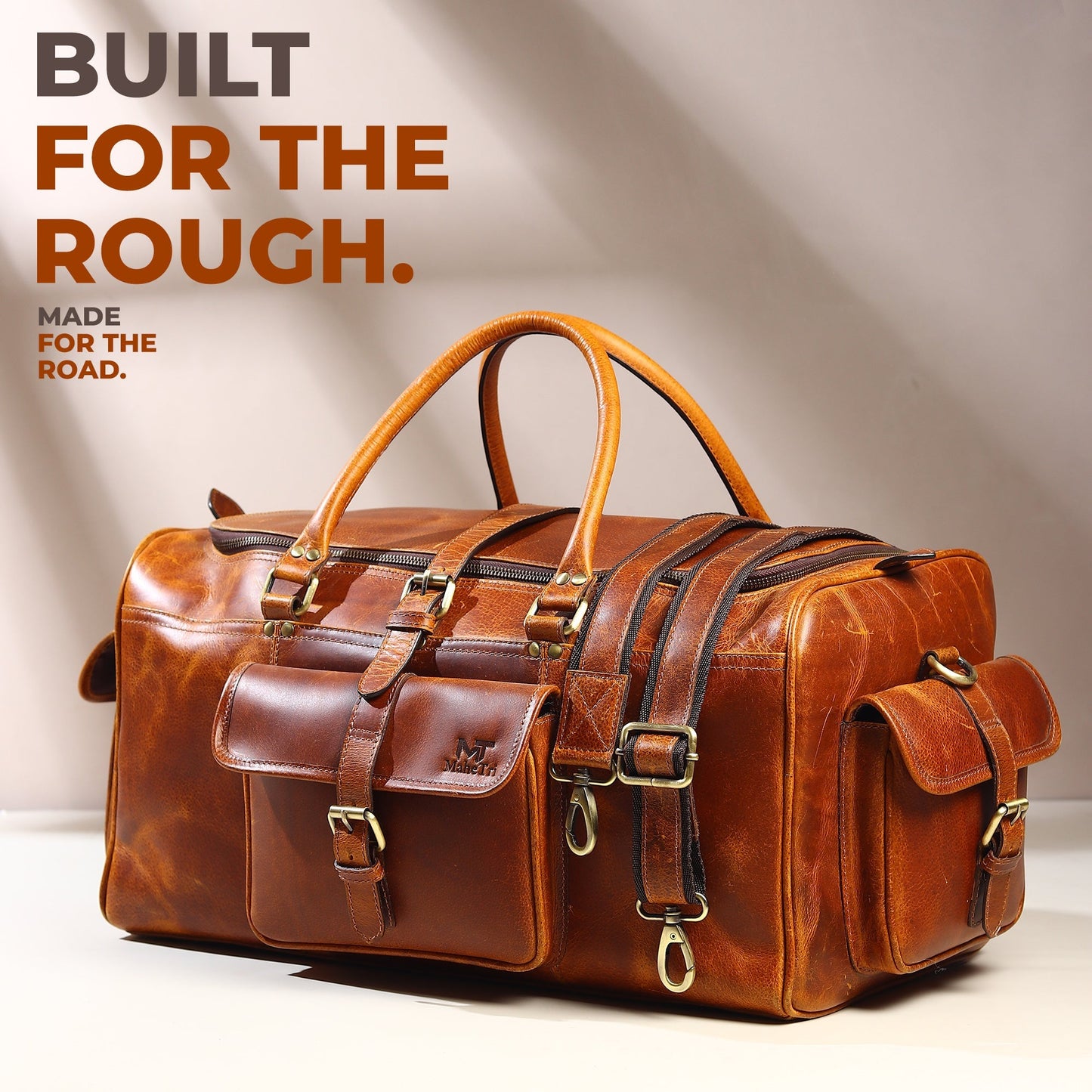 Berlin leather weekender duffle bag in brown leather with buckled front organizer and side tabs