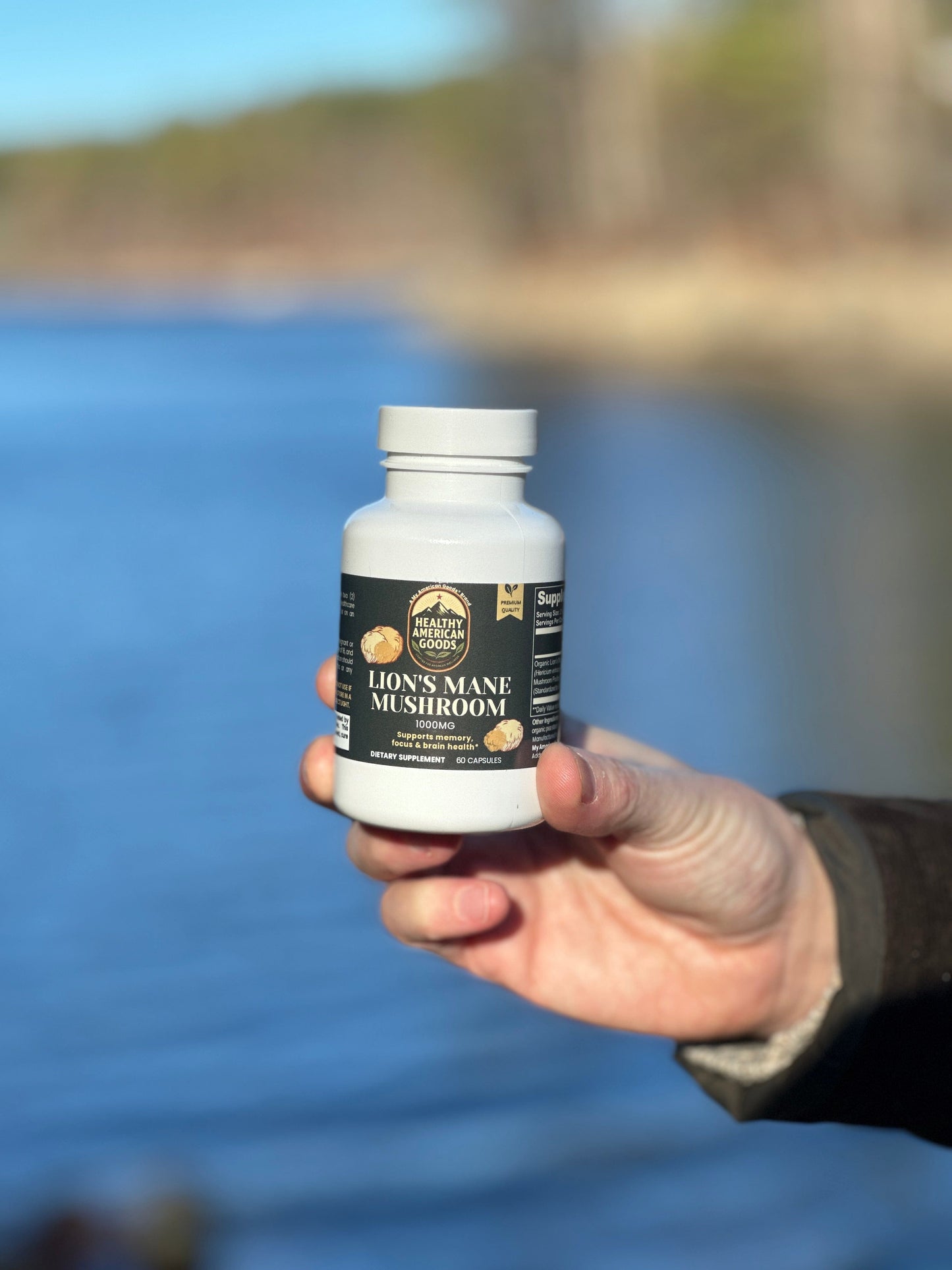 Mushroom supplement bottle held in hand, white cap, green label showing Lion's Mane