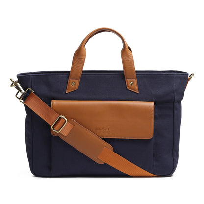 Dark blue canvas leather briefcase with tan top handles, front flap pocket, crossbody strap
