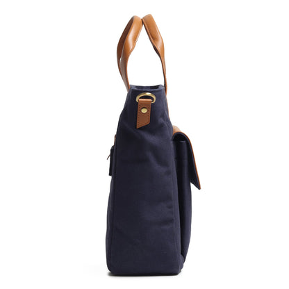 Dark blue canvas leather briefcase side view with tan leather handle and small zipper pocket