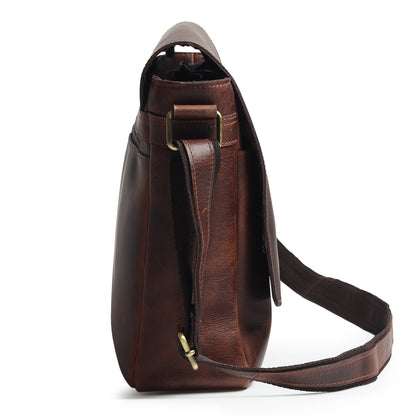 Brown leather laptop messenger bag with vertical strap attachment and front flap