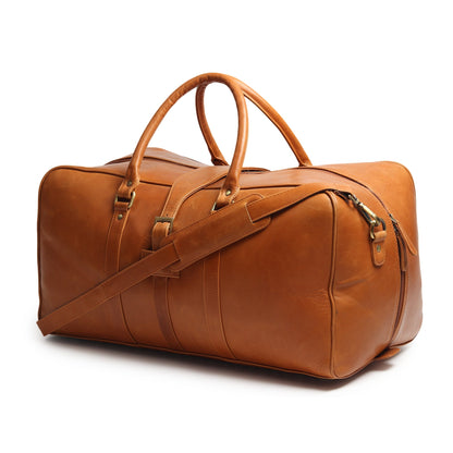 Tan leather duffle travel bag with top handles and front shoulder strap, metal hardware