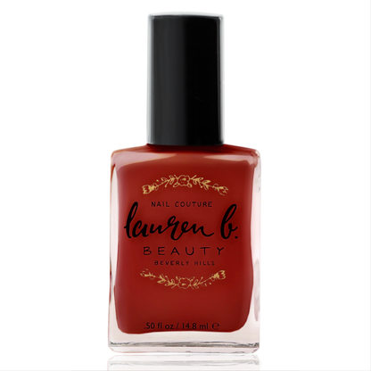 Nail polish bottle in deep red crème with black cap