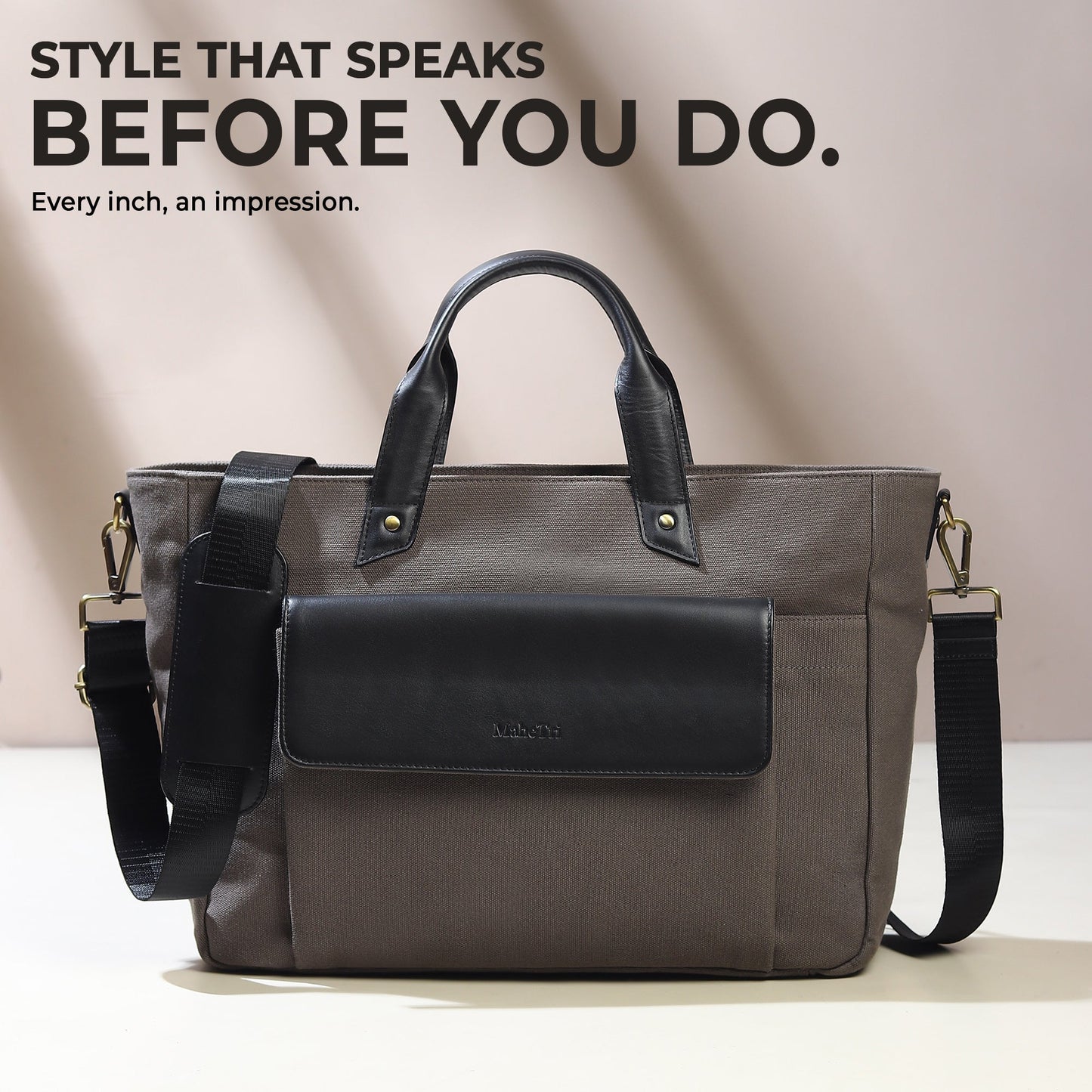 Gray canvas leather briefcase with black front flap and crossbody strap.