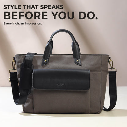 Gray canvas leather briefcase with black front flap and crossbody strap.