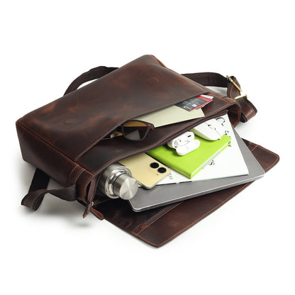 Brown leather laptop bag with open flap showing organizer compartments