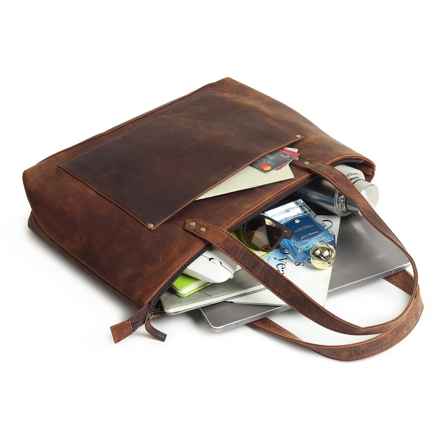 Brown leather tote bag open at top showing cards and tablet inside