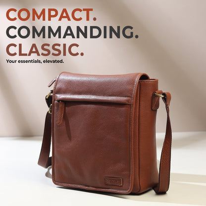 Brown leather crossbody bag with front flap, buckled straps, and small brand patch